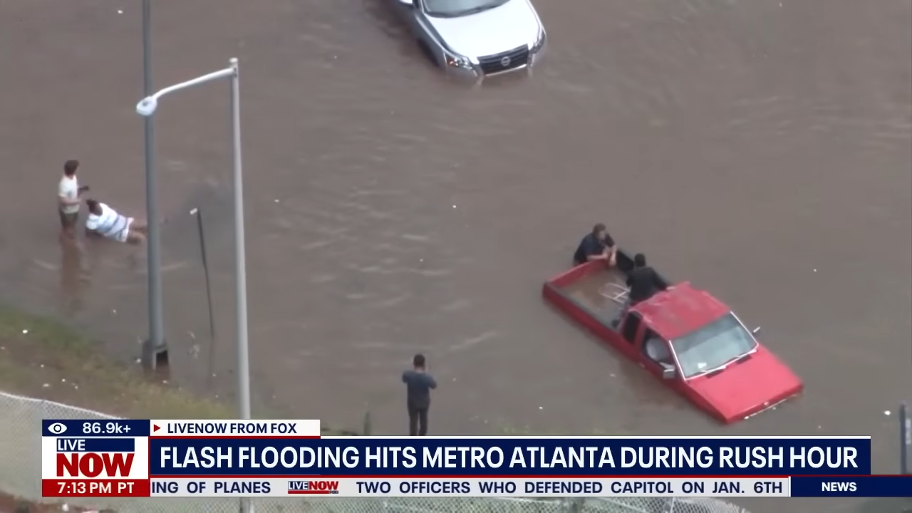 Vista aérea de via expressa em Atlanta tomada pela água, carros submersos durante enchente